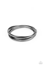 Load image into Gallery viewer, A set of four plain gunmetal bangles interlocks with four glistening gunmetal bangles etched in a tread-like pattern, creating an edgy stacked look around the wrist
