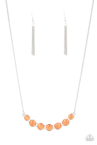 A row of glowing orange cat's eye stones are held in place by a series of interconnected shiny silver frames, creating a whimsically scalloped pendant below the collar. Features an adjustable clasp closure.