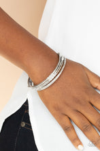 Load image into Gallery viewer, Pairs of plain, textured, and white rhinestone adorned silver bangles glide along the wrist for a sparkly look
