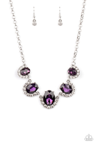 Gradually increasing in size at the center, the sparkly bottoms of oversized purple gems are bordered in rows of glassy white rhinestones as they link below the collar for a dramatic effect. Features an adjustable clasp closure.