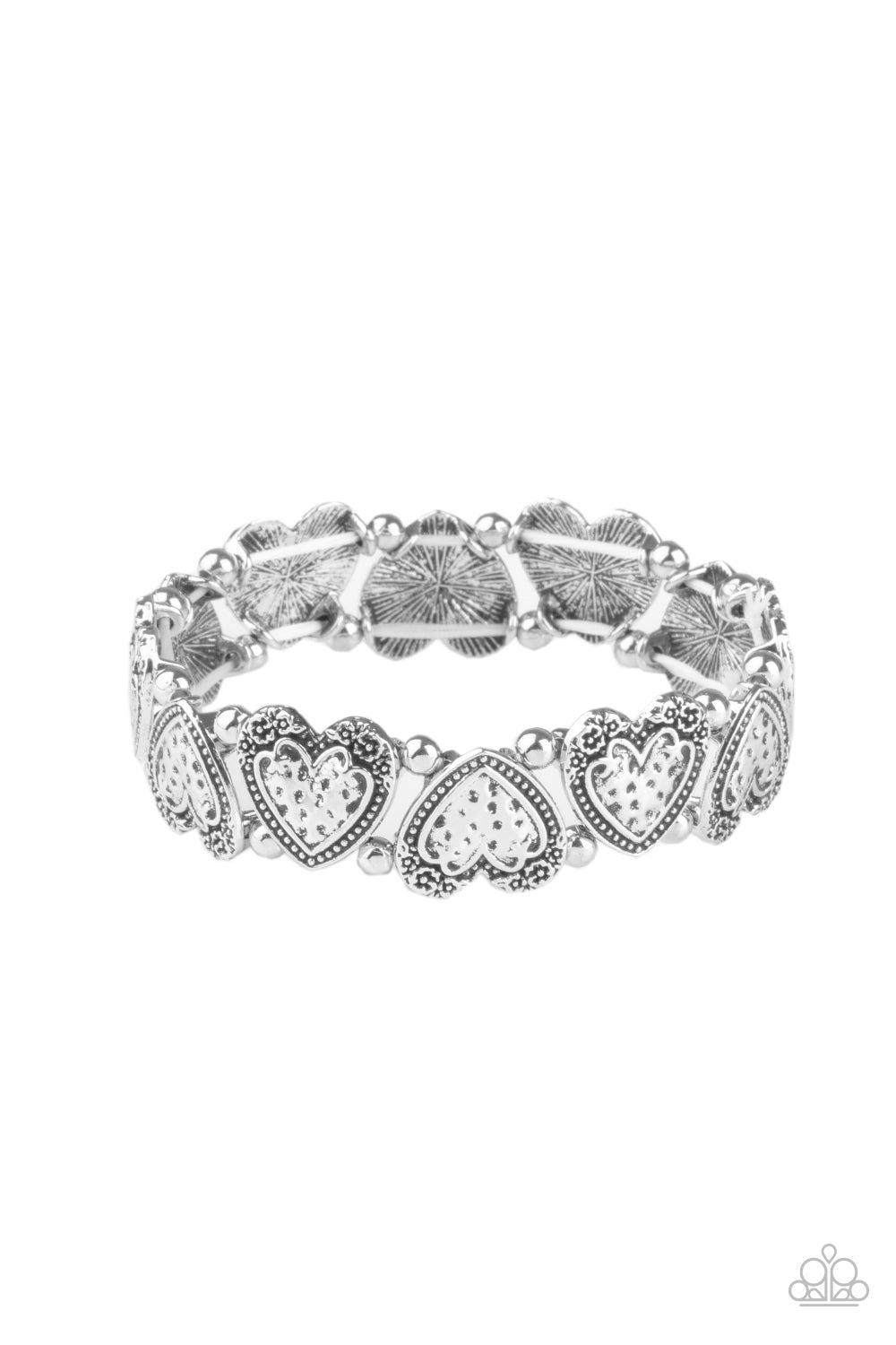 Adorned in dainty floral accents, hammered silver heart frames and classic silver beads are threaded along stretchy bands around the wrist for a romantically rustic look