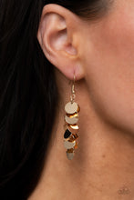 Load image into Gallery viewer, A shimmery collection of dainty gold discs trickle along a dainty gold chain, creating a clustered tassel. Earring attaches to a standard fishhook fitting. 
