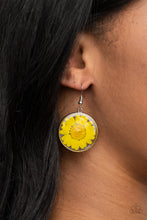 Load image into Gallery viewer, Bordered in a silver fitting, a pressed yellow daisy is encased inside a glassy frame for an enchanted floral look. Earring attaches to a standard fishhook fitting.
