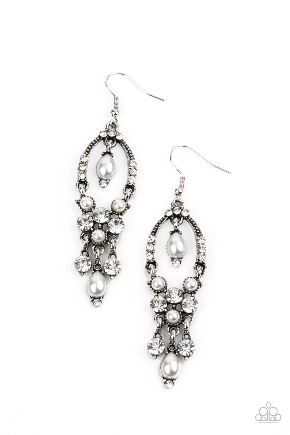 Glittery white rhinestones and pearly white beaded fittings delicately swing from the bottom of an ornately embellished oval frame. A matching pearly frame dangles from the top of the decorative silver frame, adding a timeless movement to the sparkly display. Earring attaches to a standard fishhook fitting.