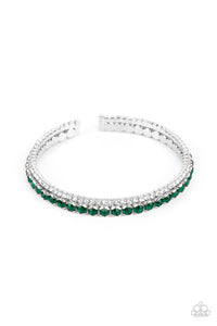 Mismatched strands of glassy white and glittery green rhinestones stack into a dainty cuff around the wrist, creating a sparkly centerpiece. 