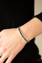 Load image into Gallery viewer, Mismatched strands of glassy white and glittery green rhinestones stack into a dainty cuff around the wrist, creating a sparkly centerpiece. 
