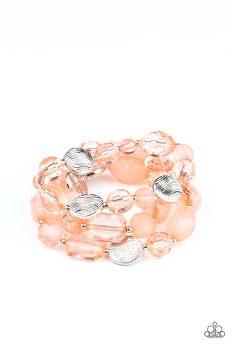 Glassy and opaque coral crystal-like beads and textured silver accents are threaded along stretchy bands around the wrist, creating mystical layers