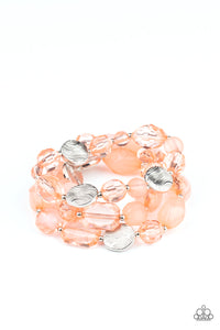 Glassy and opaque coral crystal-like beads and textured silver accents are threaded along stretchy bands around the wrist, creating mystical layers