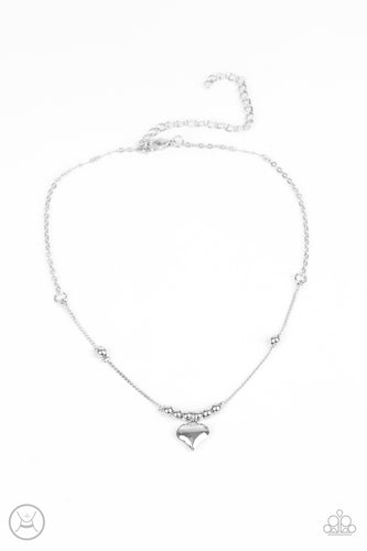 Infused with dainty silver beads, a charming silver heart dangles from a wire-like chain around the neck for a flirtatious look. Features an adjustable clasp closure. 