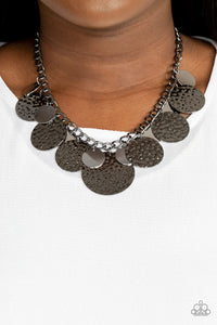 Oversized silver discs and hammered gunmetal discs swing from the bottom of a chunky gunmetal chain, creating a rambunctious fringe below the collar. Features an adjustable clasp closure.