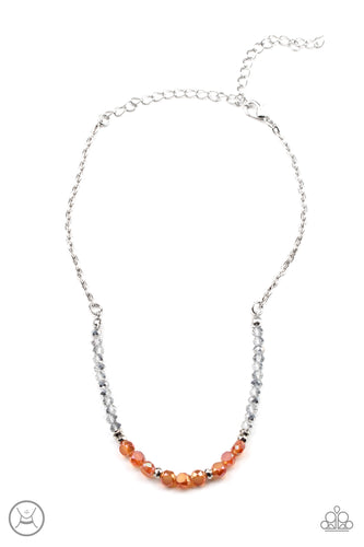 A dainty collection of mismatched silver beads, hematite flecked accents, and orange crystal-like accents are threaded along an invisible wire around the neck for a stellar look. Features an adjustable clasp closure.
