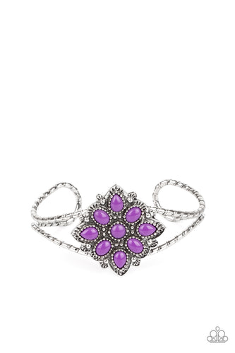 Purple teardrop beads embellish a decoratively studded frame atop a textured silver cuff, creating a whimsical pop of color atop the wrist.