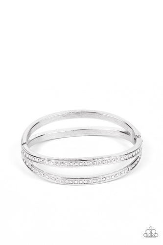 Encrusted in glassy white rhinestones, an oval silver frame attaches to a matching shiny frame, creating a timelessly layered bangle-like cuff around the wrist. Features a hinged closure. 