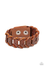 Load image into Gallery viewer, Brown leather laces loop around interconnected leather links, creating a rustic display around the wrist. Features an adjustable snap closure.
