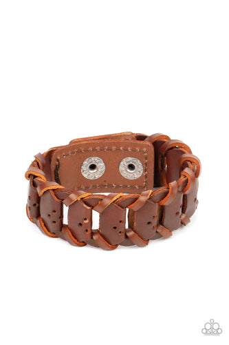 Brown leather laces loop around interconnected leather links, creating a rustic display around the wrist. Features an adjustable snap closure.