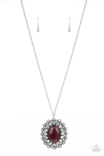 Bordered in bubbly white rhinestone encrusted petals, the center of a studded silver floral frame is dotted with an oversized purple cat's eye stone, creating a whimsical medallion at the bottom of a lengthened silver chain. Features an adjustable clasp closure.