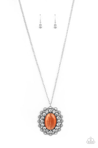 Bordered in bubbly white rhinestone encrusted petals, the center of a studded silver floral frame is dotted with an oversized orange cat's eye stone, creating a whimsical medallion at the bottom of a lengthened silver chain. Features an adjustable clasp closure.