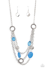 Load image into Gallery viewer, Varying in shape and opacity, glassy French Blue crystal-like beads, asymmetrical silver discs, and textured silver rings haphazardly adorn three silver chains below the collar for a whimsical pop of color. Features an adjustable clasp closure.
