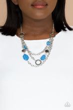 Load image into Gallery viewer, Varying in shape and opacity, glassy French Blue crystal-like beads, asymmetrical silver discs, and textured silver rings haphazardly adorn three silver chains below the collar for a whimsical pop of color. Features an adjustable clasp closure.
