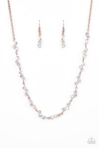 Attached to a dainty rose gold chain, trios of iridescent crystal-like beads are delicately threaded along rose gold rods below the collar for a timelessly twinkly look. Features an adjustable clasp closure.