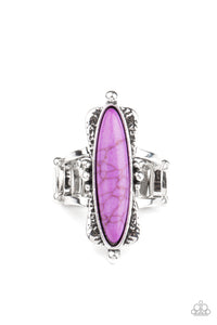 An oblong purple stone is pressed into a flared silver frame featuring studded accents, creating an abstract centerpiece atop the finger. Features a stretchy band for a flexible fit