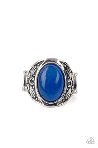 An oversized lapis lazuli stone is pressed into the center of a thick silver frame embossed in antiqued tribal inspired patterns, creating an enchanting centerpiece atop the finger. Features a stretchy band for a flexible fit. 