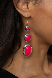 Mismatched glassy pink beads are encased in sleek silver frames that whimsically link into a colorfully retro lure. Earring attaches to a standard fishhook fitting. 