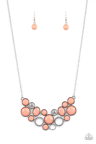 A mismatched collection of faceted coral beaded frames and white rhinestone embellished accents delicately connect into a bubbly clustered pendant below the collar, creating a colorful statement piece. Features an adjustable clasp closure. 