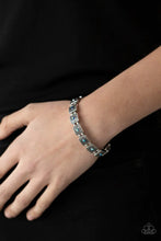 Load image into Gallery viewer, Dotted with iridescent blue rhinestone centers, studded silver frames alternate with pairs of dainty silver beads along stretchy bands, creating a stellar centerpiece around the wrist.
