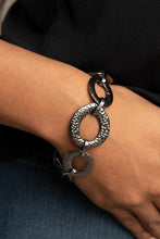 Load image into Gallery viewer, Asymmetrical gunmetal links and hammered oval frames delicately connect around the wrist for an intense industrial look. Features an adjustable clasp closure.
