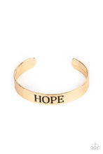 Load image into Gallery viewer, The center of a shiny gold cuff is stamped in the word, &quot;Hope,&quot; for an inspirational look.
