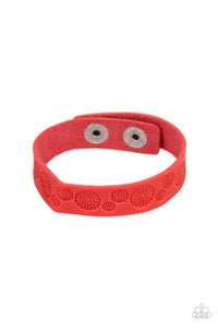 Stamped in a whimsical daisy pattern, a dainty red leather band wraps around the wrist for a seasonal flair. Features an adjustable snap closure.