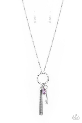 A purple teardrop gem, silver key, dainty crystal-like bead, and shimmery silver chain tassel swings from the bottom of a silver ring at the bottom of a lengthened silver chain, creating a whimsically tasseled display. Features an adjustable clasp closure.