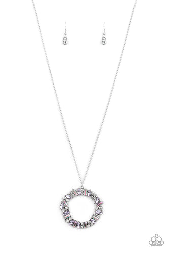 Marquise cut purple rhinestones, classic white rhinestones, and iridescent emerald style rhinestones are encrusted along the front of a circular frame, creating an elegant wreath at the bottom of a lengthened silver chain. Features an adjustable clasp closure. 