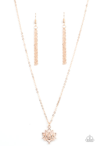 A shiny rose gold lotus blooms along a dainty rose gold chain, creating a whimsical pendant below the collar. Features an adjustable clasp closure. 