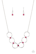 Load image into Gallery viewer, Glittery pink rhinestones link a dainty row of silver rings below the collar, creating a regal minimalist inspired display. Features an adjustable clasp closure.
