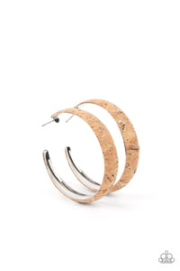 Silvery veins accent the front of a cork lined silver hoop, creating a refined display. Hoop measures approximately 2" in diameter. Earring attaches to a standard post fitting.