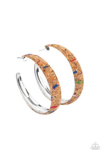 A cork lined silver hoop is splattered in multicolored paint, creating a colorful display. Hoop measures approximately 2