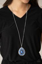 Load image into Gallery viewer, A dainty collection of round and teardrop French Blue beads flair out from an oversized teardrop bead across the front of an ornate frame. Embossed and cutout in geometric patterns, the tribal inspired pendant swings from the bottom of a lengthened silver chain for a dramatic pop of color. Features an adjustable clasp closure.
