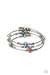 A shimmery collection of dainty gunmetal beads, oil spill crystal-like accents, and gunmetal rods are threaded along a coiled wire around the wrist, creating a stellar infinity wrap bracelet.