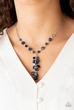 Load image into Gallery viewer, A faceted collection of metallic blue crystal-like beads delicately links below the collar. A tassel of matching beads cascades from the center, creating a stellar extended pendant. Features an adjustable clasp closure.
