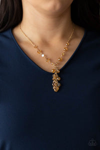 Dipped in a rainbow iridescence, a faceted collection of golden crystal-like beads delicately links below the collar. A tassel of matching beads cascades from the center, creating a stellar extended pendant. Features an adjustable clasp closure.