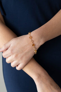 Dipped in a rainbow iridescence, a faceted collection of golden crystal-like beads delicately links around the wrist for a stellar pop of color. Features an adjustable clasp closure.