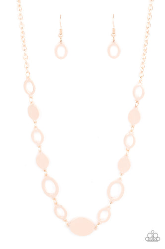 A shiny series of glistening rose gold discs and oval frames delicately link below the collar, creating a casual statement. Features an adjustable clasp closure