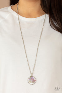 A leafy collection of colorful wildflowers is encased inside a glassy frame, creating a whimsical pendant at the bottom of the lengthened silver chain. Features an adjustable clasp closure.