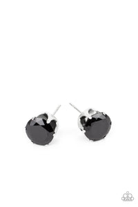 An oversized black rhinestone is nestled inside a pronged silver fitting, creating a timeless statement piece. Earring attaches to a standard post fitting.