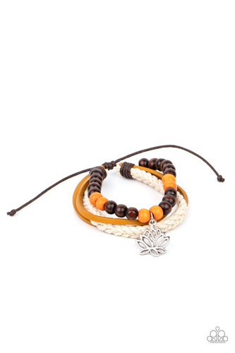 Featuring a silver lotus charm, a strand of brown and orange wooden beads, braided white cording, and strands of brown leather layer around the wrist for a seasonal flair. Features an adjustable sliding knot closure.