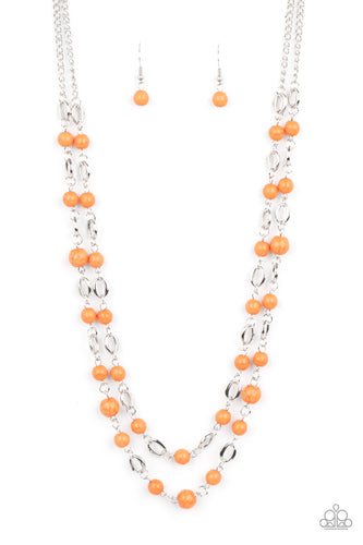An earthy collection of orange stones link with silver oval frames below the collar, creating a colorfully layered display. Features an adjustable clasp closure. 