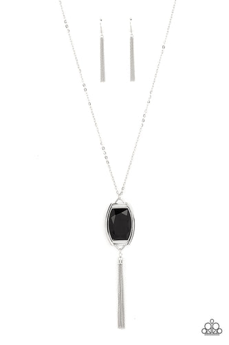Encased in an antiqued silver frame, an oversized black gem swings from the bottom of an ornate silver chain. A shimmery silver chain tassel swings from the bottom of the sparkly pendant, creating a regal talisman. Features an adjustable clasp closure. 