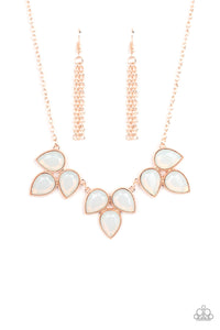 Trios of faceted iridescence, dewy white teardrop beads, encased in studded rose gold casings coalesce into leafy frames that delicate link into an ethereal fringe below the collar. Features an adjustable closure.
